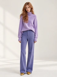 Woman in a purple outfit used as a character reference for an AI video.
